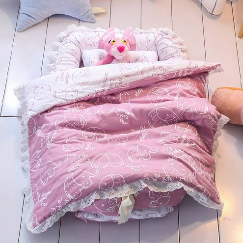 Soft cotton pink baby sleeping bed with a cute cartoon animal design, cozy padded sides, and colorful plush toys, creating a comfortable and playful.