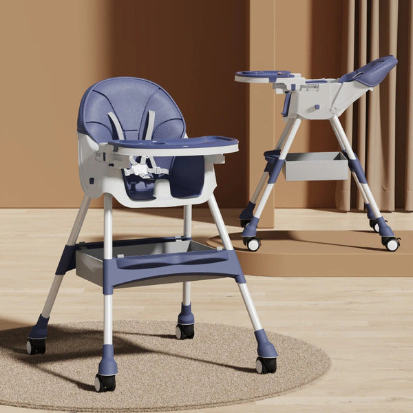 Blue and white  booster seats high chair with tray on a wooden floor.