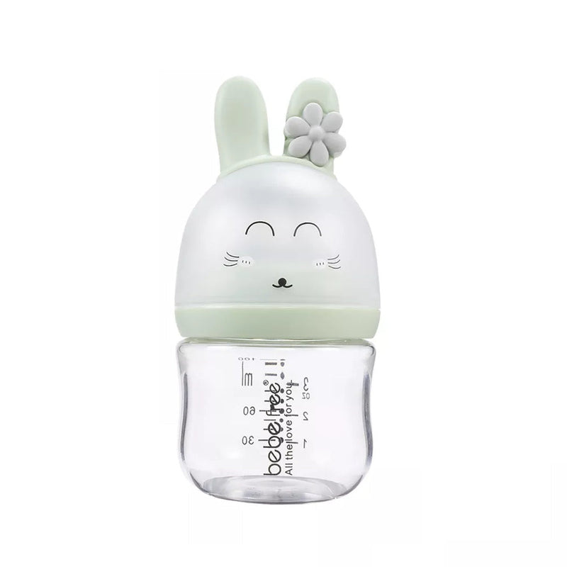 Anti colic feeding bottle with a green bunny-shaped cap .