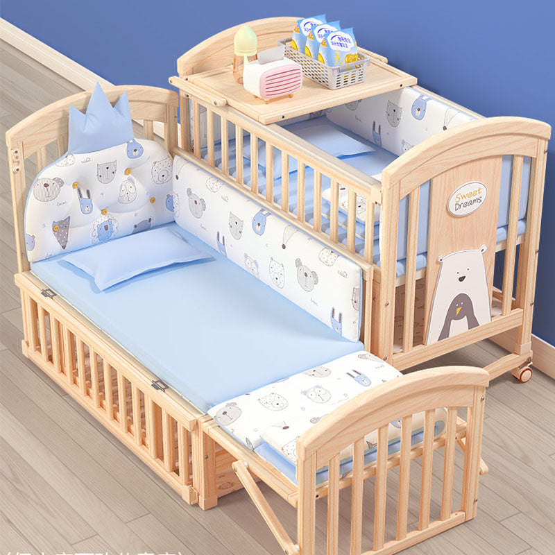 Wooden crib with baby bedding and accessories .