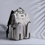 Multifunctional waterproof gray mummy backpack with a spacious interior, multiple compartments, insulated bottle storage, durable construction, and comfortable adjustable shoulder straps.