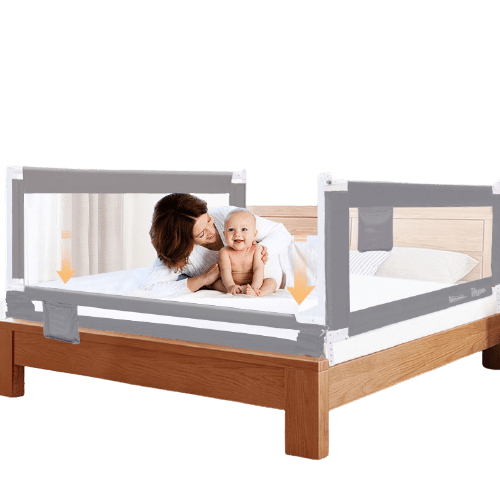portable toddler bed with a gray safety rail and a baby and woman on the bed.