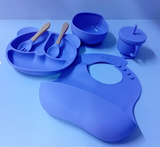 Blue children's silicone dining set including plate, bowl, cups, and bib .