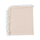 Beige soft muslin swaddle blanket with white pom-pom trim .