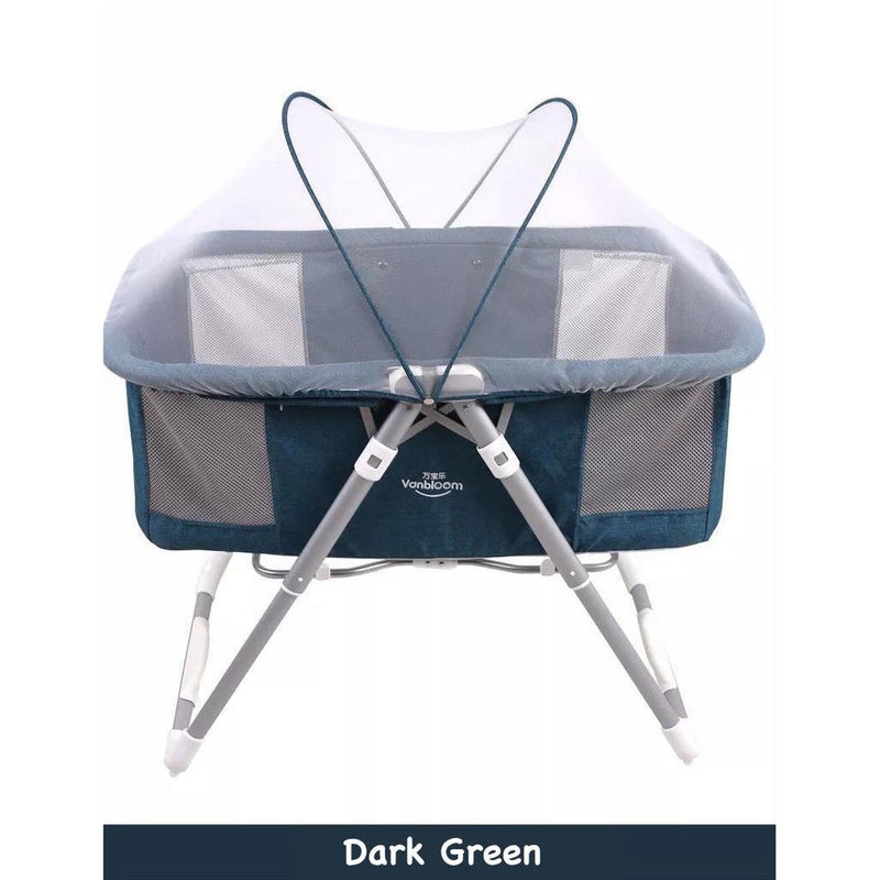 2 in 1 portable baby cot and bassinet Dark green baby crib with mesh sides .