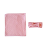 Pink polka dot swaddle blanket and matching headband wrap.