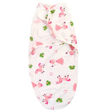 Newborn Baby organic swaddle with pink dog pattern .