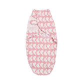 Pink baby swaddle with white patterns .