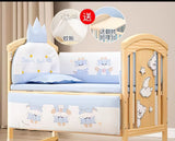 Children's crib with bedding set of cartoon design and additional items on a neutral background