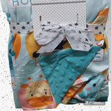 Baby comfort blanket with cartoon characters and a bow .