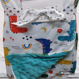 Children's cute plush blanket with dinosaur pattern and textured corner.
