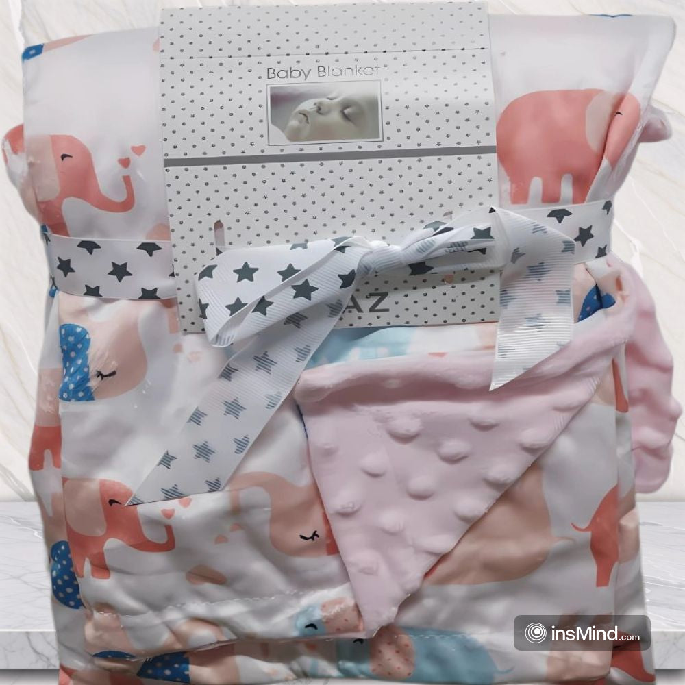 Baby blanket with elephant pattern and pink textured reverse side.