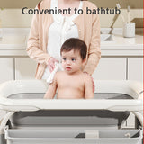 Child being bathed in a portable2 in 1 height adjustable bathtubwith safety strap.