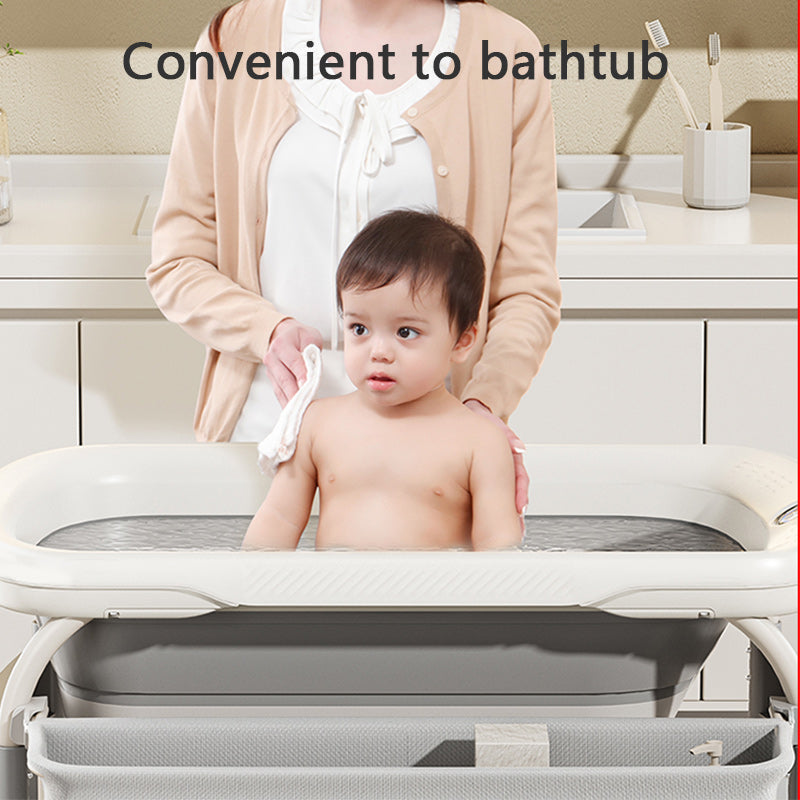 Child being bathed in a portable2 in 1 height adjustable bathtubwith safety strap.
