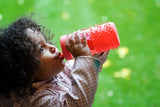 Child drinking from a Meliired bottle