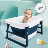 Baby in a blue and white baby bath tub with accessories .