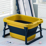 Yellow and navy folding bathtub in a bathroom setting.