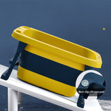 Yellow and black folding baby bath tub with a non-slip silicone pad .