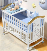White baby crib with blue bedding .
