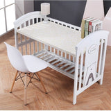 Multifunctional white baby crib with a sturdy frame, adjustable features.