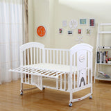White baby crib in a room .