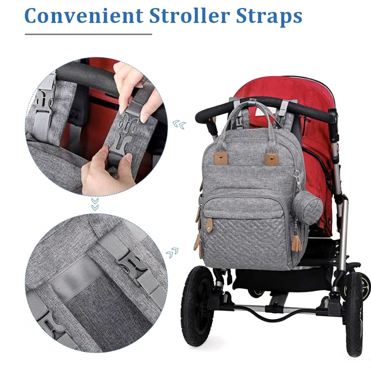 Gray multifunctional baby nappy changing backpack with stroller straps attached, featuring close-up details of the durable fabric, zippers, organized compartments, and convenient hands-free design.