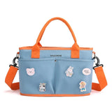 Blue bag with orange handles Tote Diaper Bag featuring cartoon stickers .