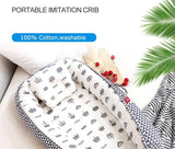  Baby Nest Portable organic breathablecrib with 100% cotton material, washable feature, and decorative elements.