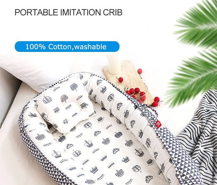  Baby Nest Portable organic breathablecrib with 100% cotton material, washable feature, and decorative elements.