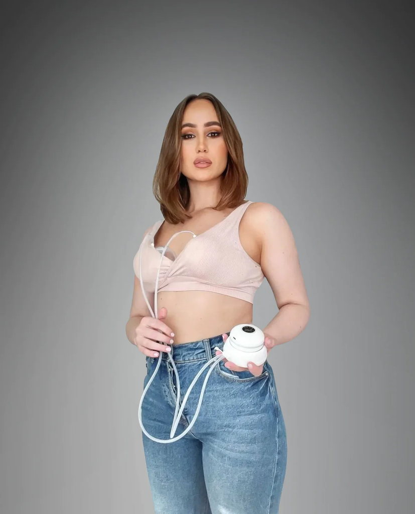 Woman holding a double wearable 3 in 1 breast pump and usb chargeable.
