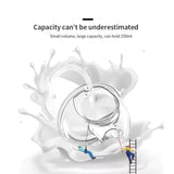 Double electric breast pump with a transparent glass milk container, visible milk splash, and clear text highlighting the container’s milk capacity.