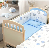 Children's crib with blue and white bedding set featuring animal patterns, next to a shelf with decorative items.