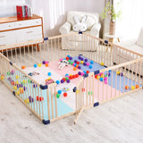 Children's playpen with colorful balls and toys inside, surrounded by a room with furniture and decor.