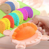 Colorful dumpling mold with a hand pressing dough in the gourmet play doh set