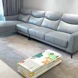 Gray sectional sofa in a living room with a high-quality foldable children's play mat on the floor.