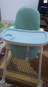 Portable green baby dining high chair.