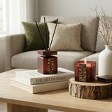 Decorative items on a coffee table with wooden scentedcandle, diffuser.
