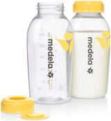 Two Medela bottles with yellow caps 