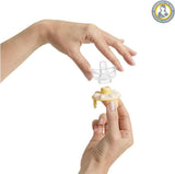 Hand holding a small Medela Calma breast milk bottle nipple.