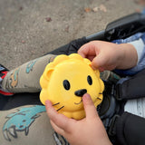 Yellow lion-shaped Meli bowl held by a child in a stroller