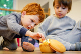 Two children having snack from melii silicone bowl.