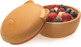 Brown Melii silicone bowl with lid filled with berries and fruits.