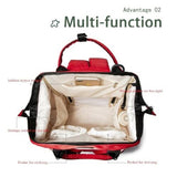 Red and black multifunctional waterproof mummy bag with labeled compartments, including insulated bottle storage, large main compartment, front zippered pocket, side pockets, and organized storage for baby essentials.