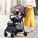 Child in a colorful luxury light weight reversible handle baby stroller.