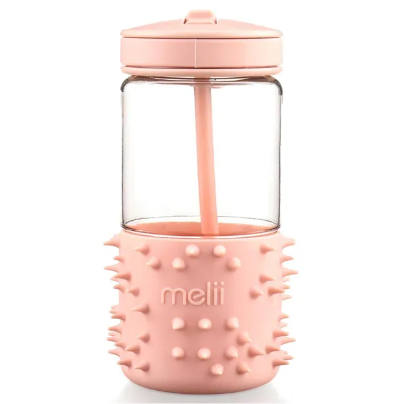 Pink tumbler with textured base and silicone sleeve, brand 'melii' .