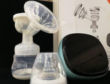 Silicone Breast pump with bottles and a black device .