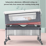 twin Baby crib with adjustable rail, featuring a baby inside, on a light pink floor with a light green wall.
