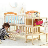 Child playing with a wooden crib and wooden foldable changing table set in a bright room.