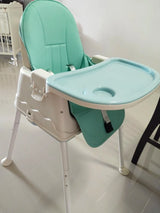 Green and white Portable feedingbaby high chair .