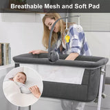 Woman with a baby in aNewborn portable crib with breathable mesh and soft pad features.